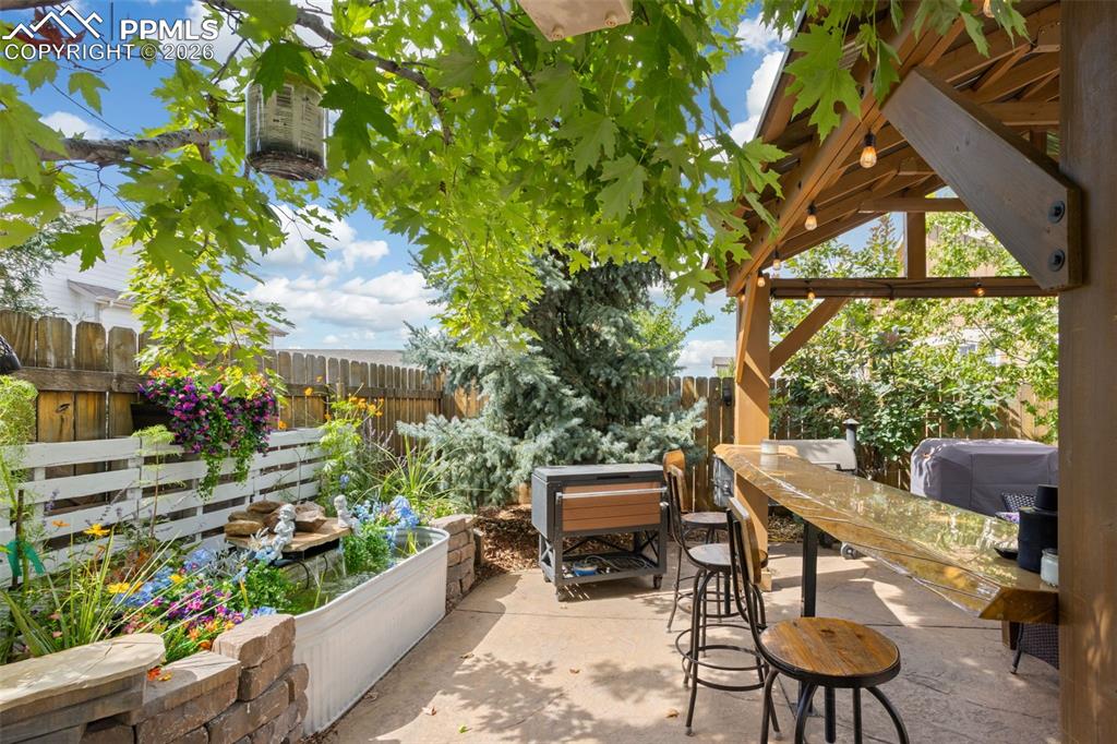 7858 Chasewood Loop Colorado Springs, CO 80908 - Photo 38 of 40 a view of a chairs and table in a yard