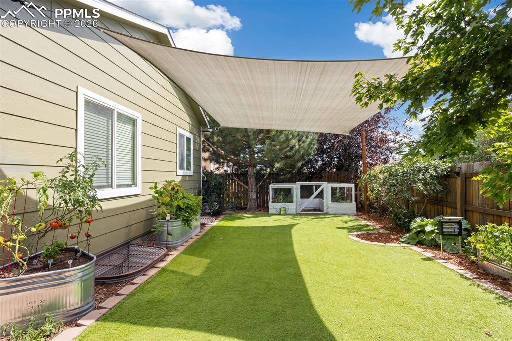 7858 Chasewood Loop Colorado Springs, CO 80908 - Photo 40 of 40 a view of a house with backyard and sitting area