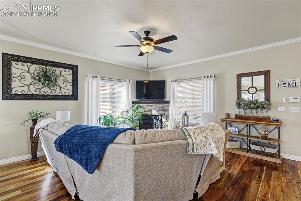 7858 Chasewood Loop Colorado Springs, CO 80908 - Photo 6 of 40 a living room with a couch and a flat screen tv