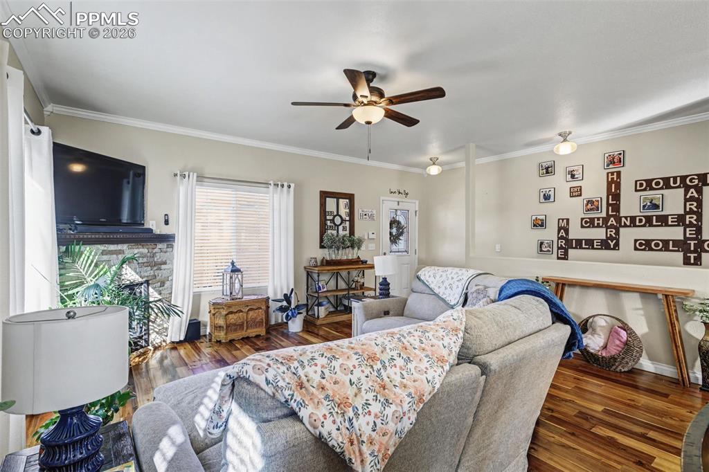 7858 Chasewood Loop Colorado Springs, CO 80908 - Photo 7 of 40 a living room with furniture and a flat screen tv