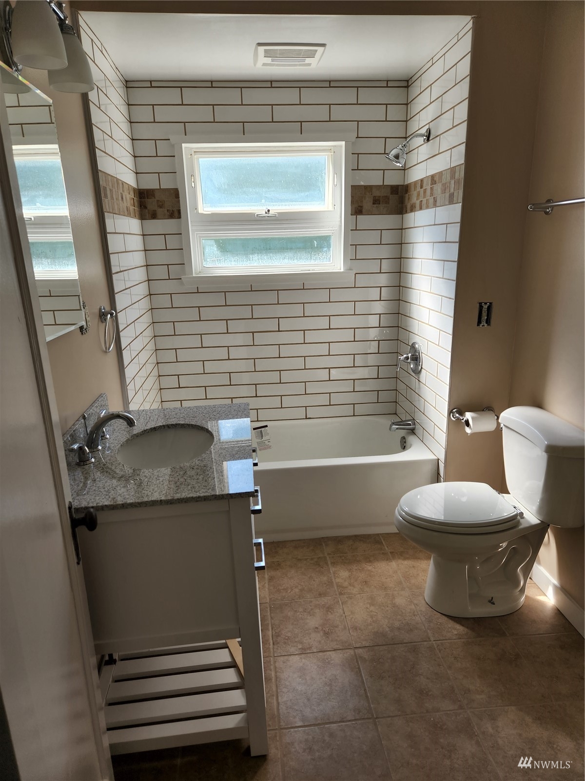7426 Lower Ridge Road Everett, WA 98203 - Photo 14 of 28 a bathroom with a granite countertop sink toilet and shower