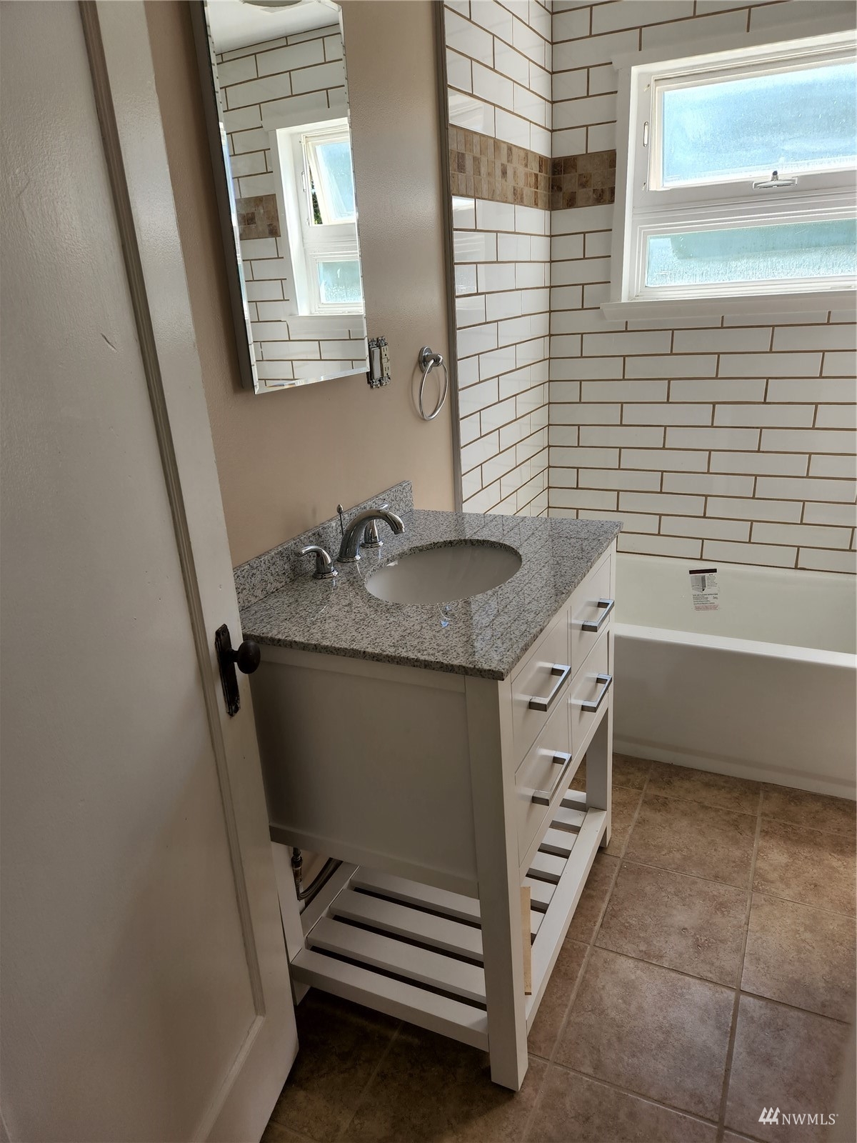 7426 Lower Ridge Road Everett, WA 98203 - Photo 15 of 28 a bathroom with a granite countertop sink a toilet and bathtub