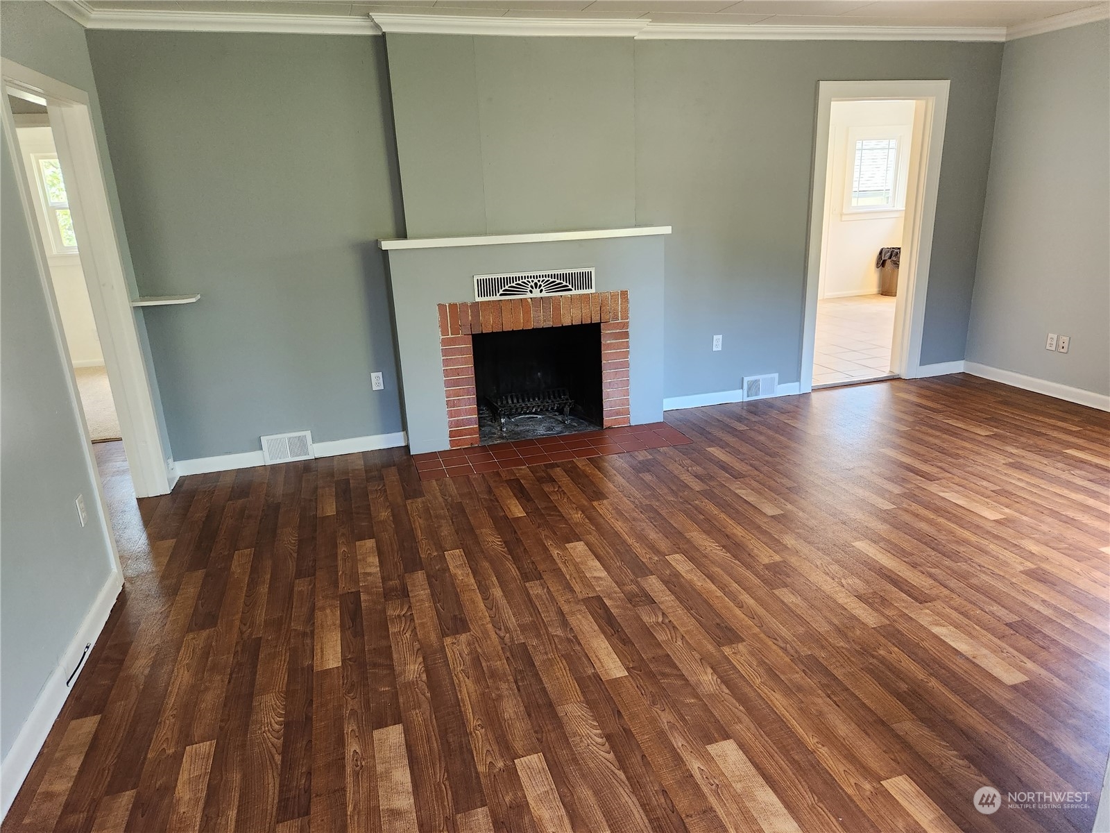 7426 Lower Ridge Road Everett, WA 98203 - Photo 6 of 28 a view of a livingroom with wooden floor and a fireplace