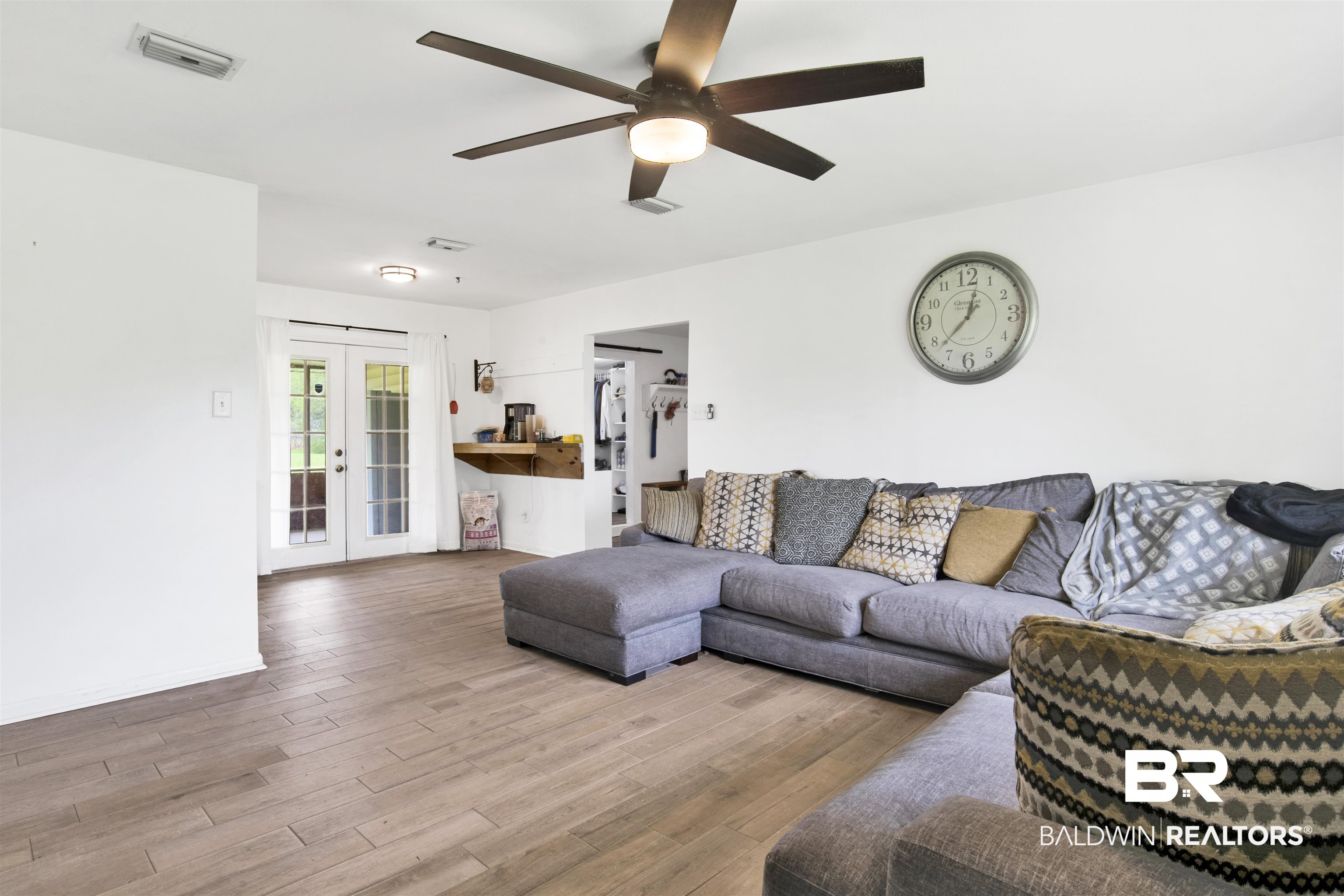 10244 Magnolia Road Irvington, AL 36544 - Photo 5 of 37 Living area with french doors, wood finished floors, ceiling fan, and visible vents