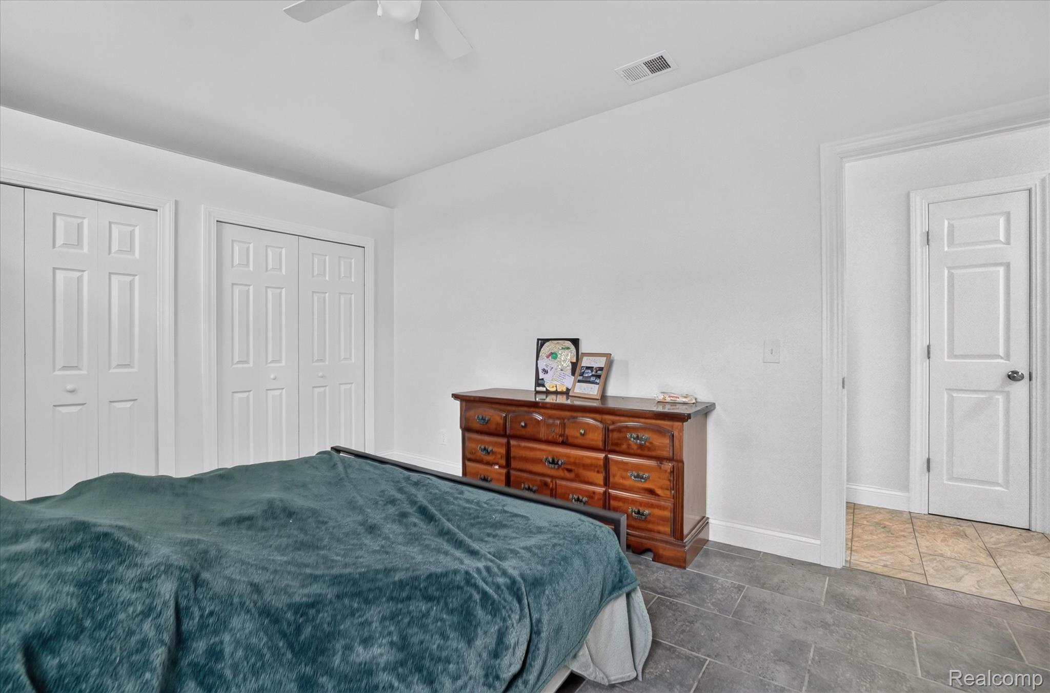 6524 Kelly Road Flushing, MI 48433 - Photo 25 of 47 Bedroom featuring slate-style tile flooring and a ceiling fan
