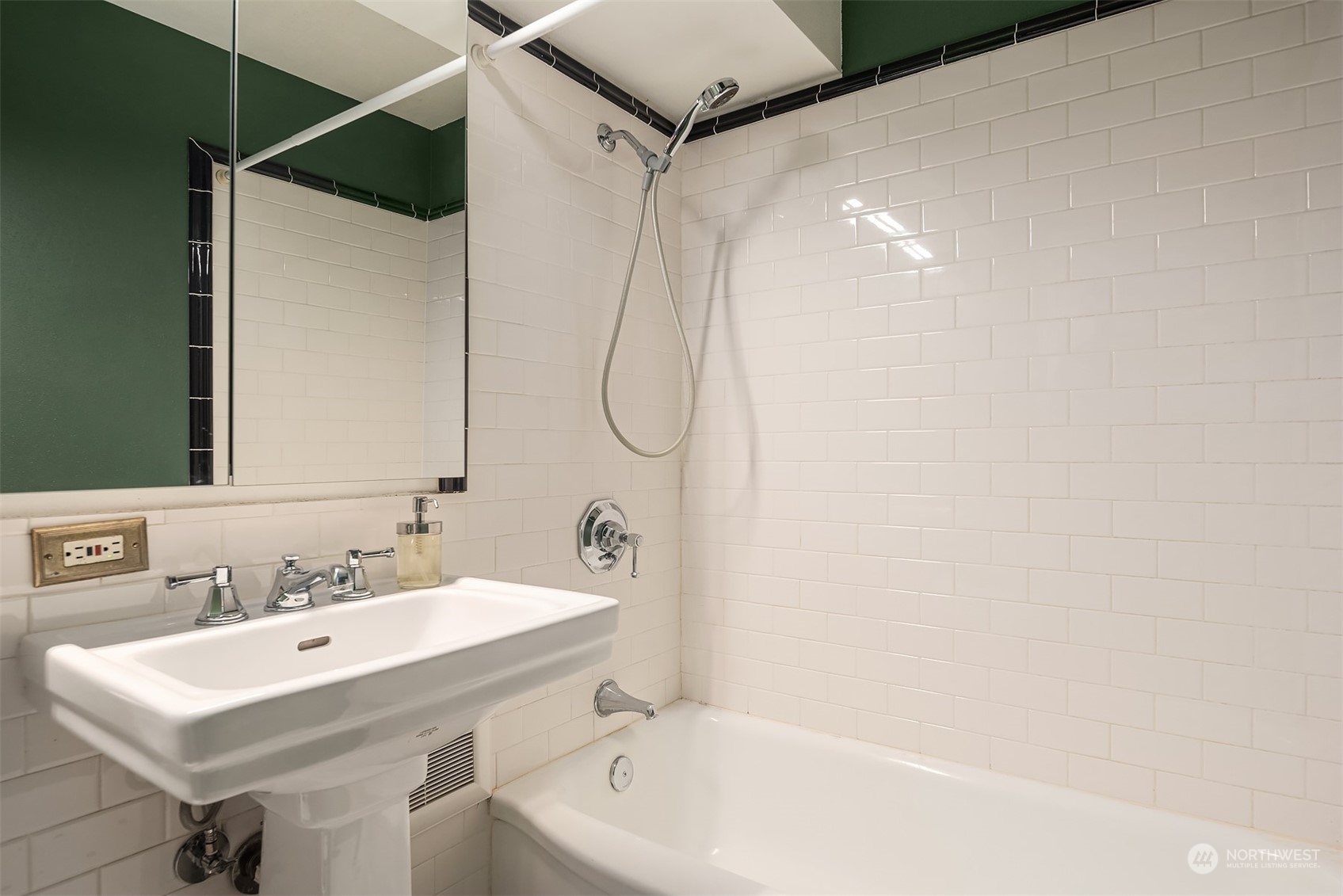 1105 Spring Street, Unit 503 Seattle, WA 98104 - Photo 11 of 18 a bathroom with a shower a sink and a mirror