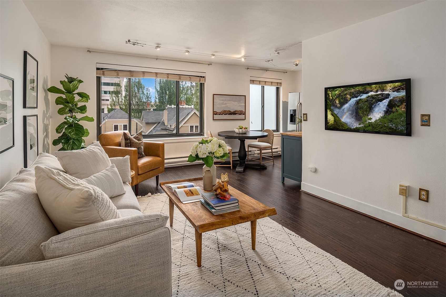 1105 Spring Street, Unit 503 Seattle, WA 98104 - Photo 2 of 18 a living room with furniture and a potted plant