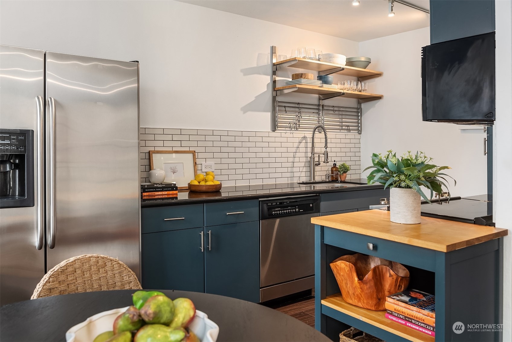 1105 Spring Street, Unit 503 Seattle, WA 98104 - Photo 6 of 18 a kitchen with a sink refrigerator and microwave