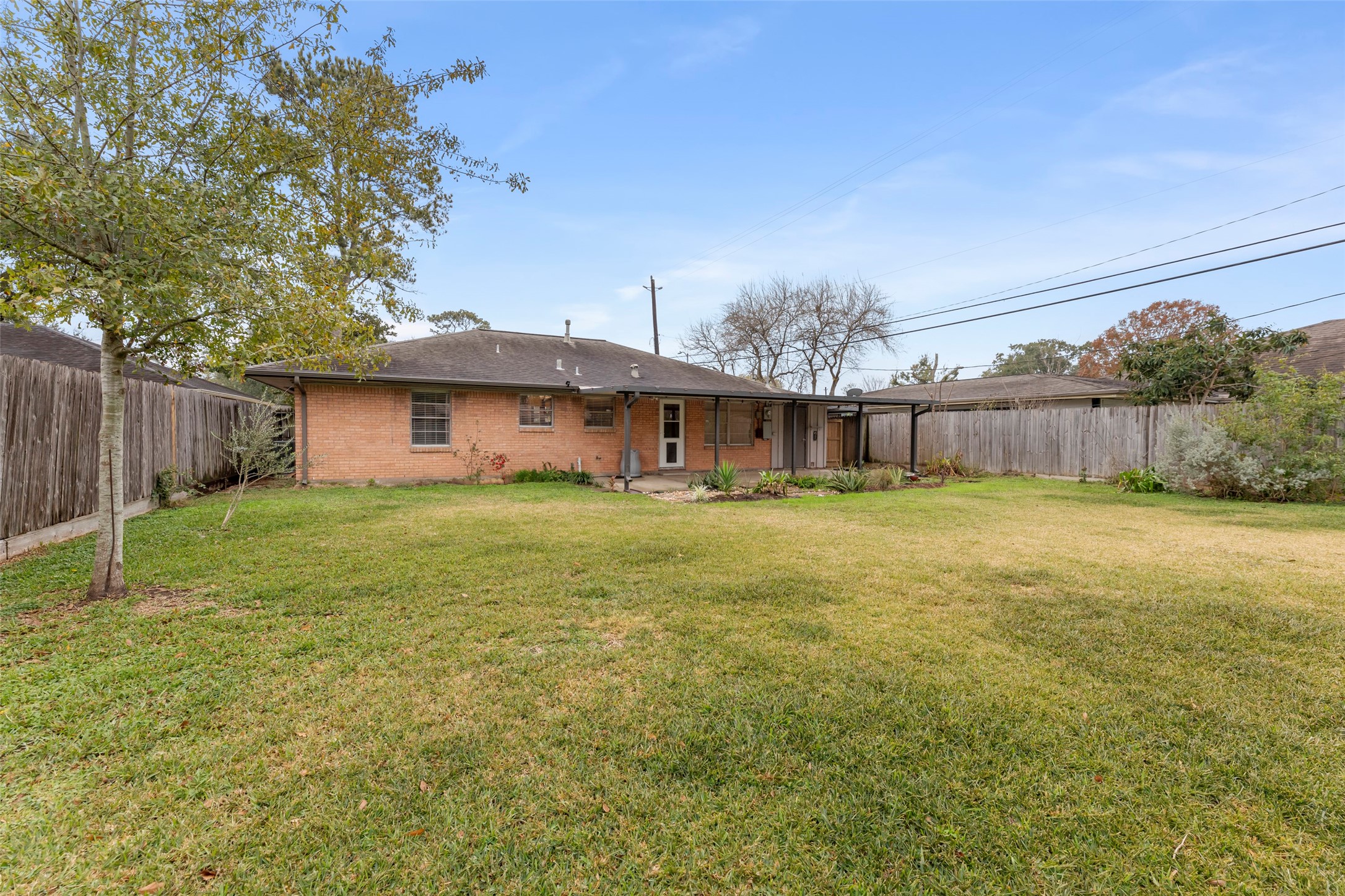 6148 Indigo Street Houston, TX 77074 - Photo 16 of 37 a view of a house with a yard