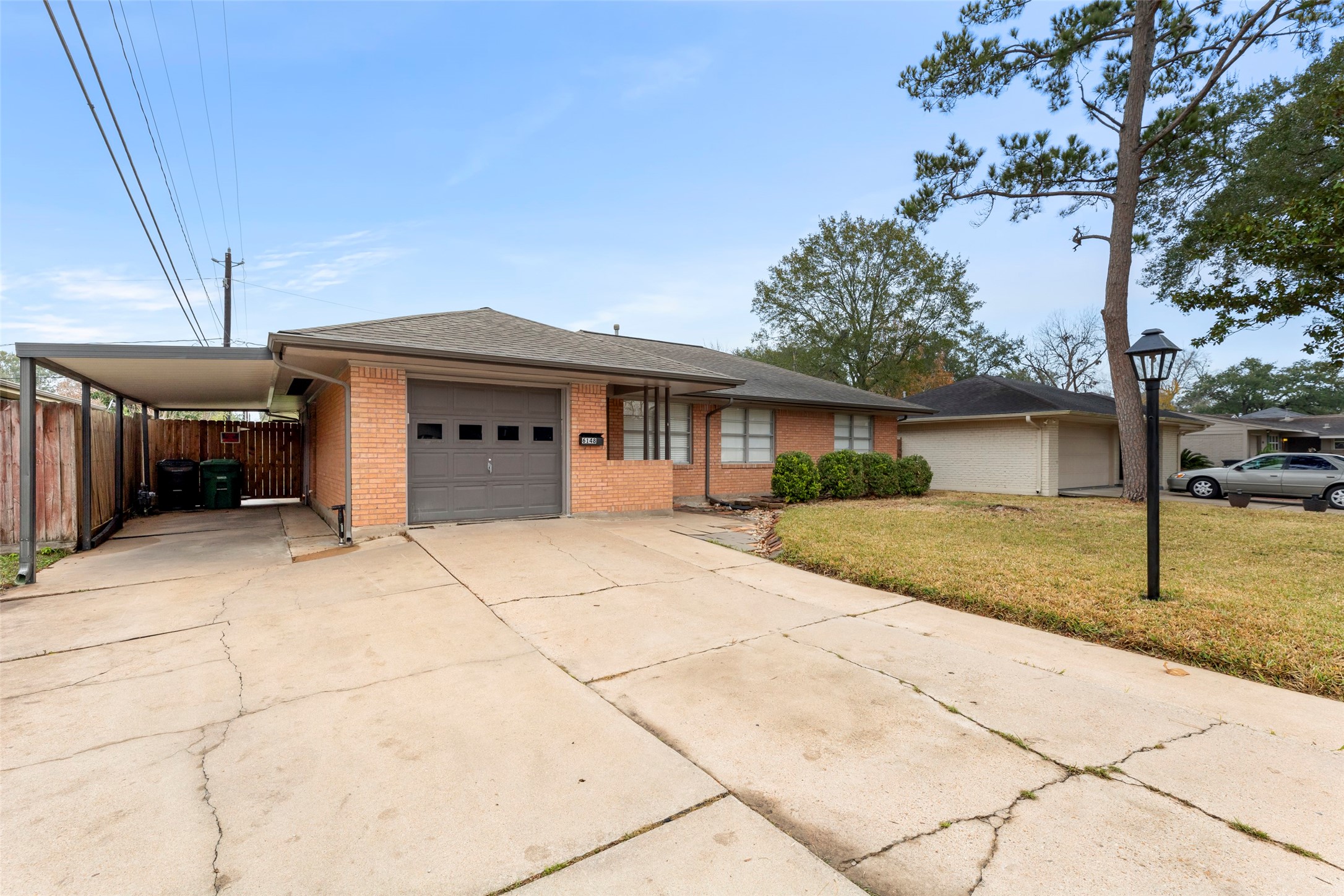 6148 Indigo Street Houston, TX 77074 - Photo 2 of 37 a view of a house with a backyard and garage