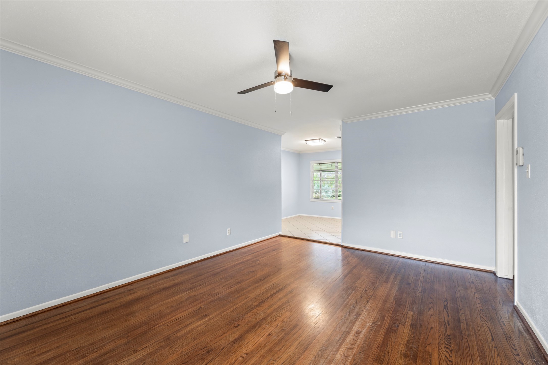 6148 Indigo Street Houston, TX 77074 - Photo 21 of 37 a view of an empty room with wooden floor ceiling fan