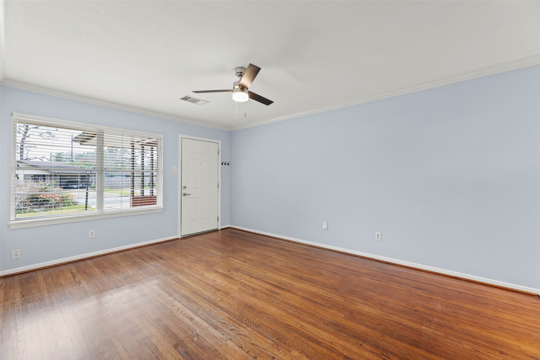 6148 Indigo Street Houston, TX 77074 - Photo 22 of 37 a view of empty room with wooden floor and fan