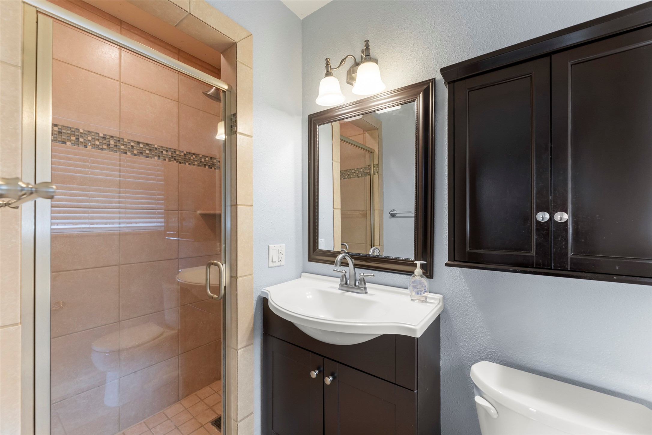 6148 Indigo Street Houston, TX 77074 - Photo 37 of 37 a bathroom with a sink a toilet and shower