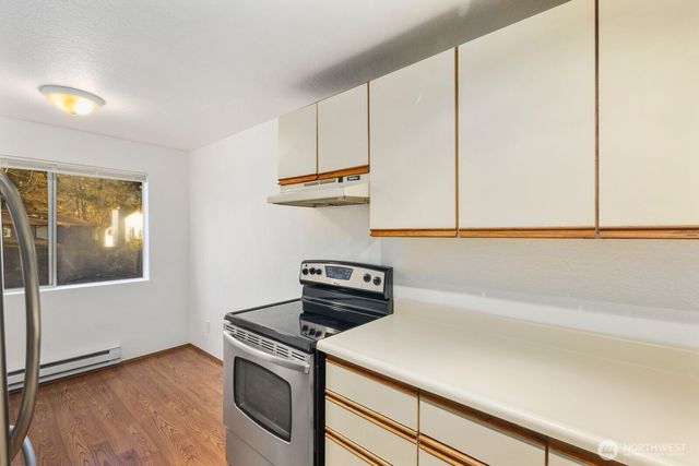 a kitchen with a stove and a microwave