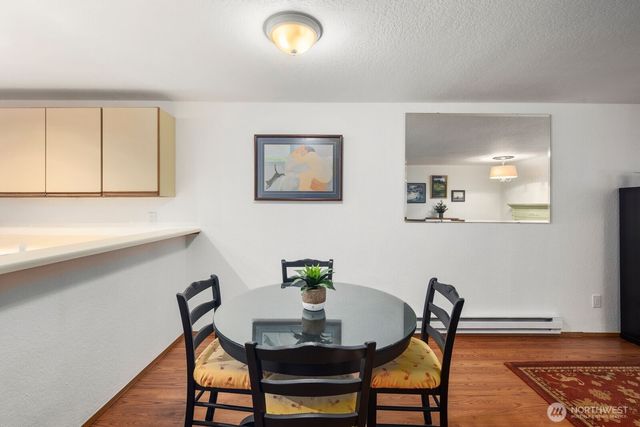 a view of a dining room with furniture and wooden floor