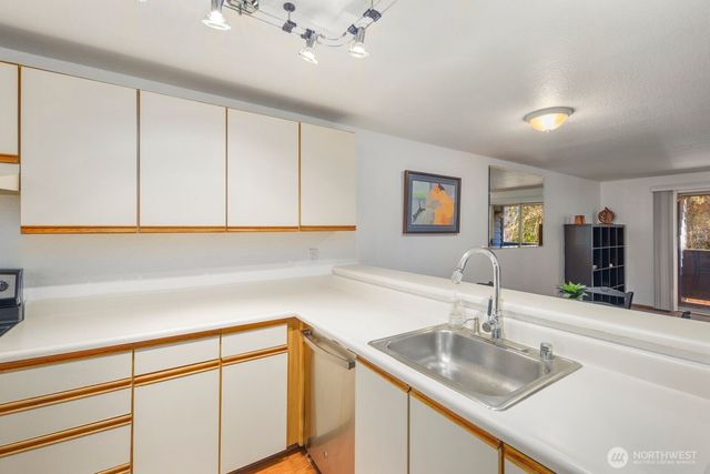 a kitchen with a sink cabinets and window
