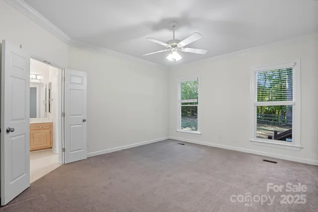 an empty room with windows and closet