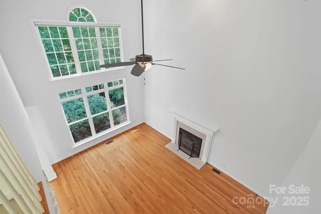 a kitchen with stainless steel appliances granite countertop a refrigerator a sink dishwasher a oven with wooden cabinets and floor