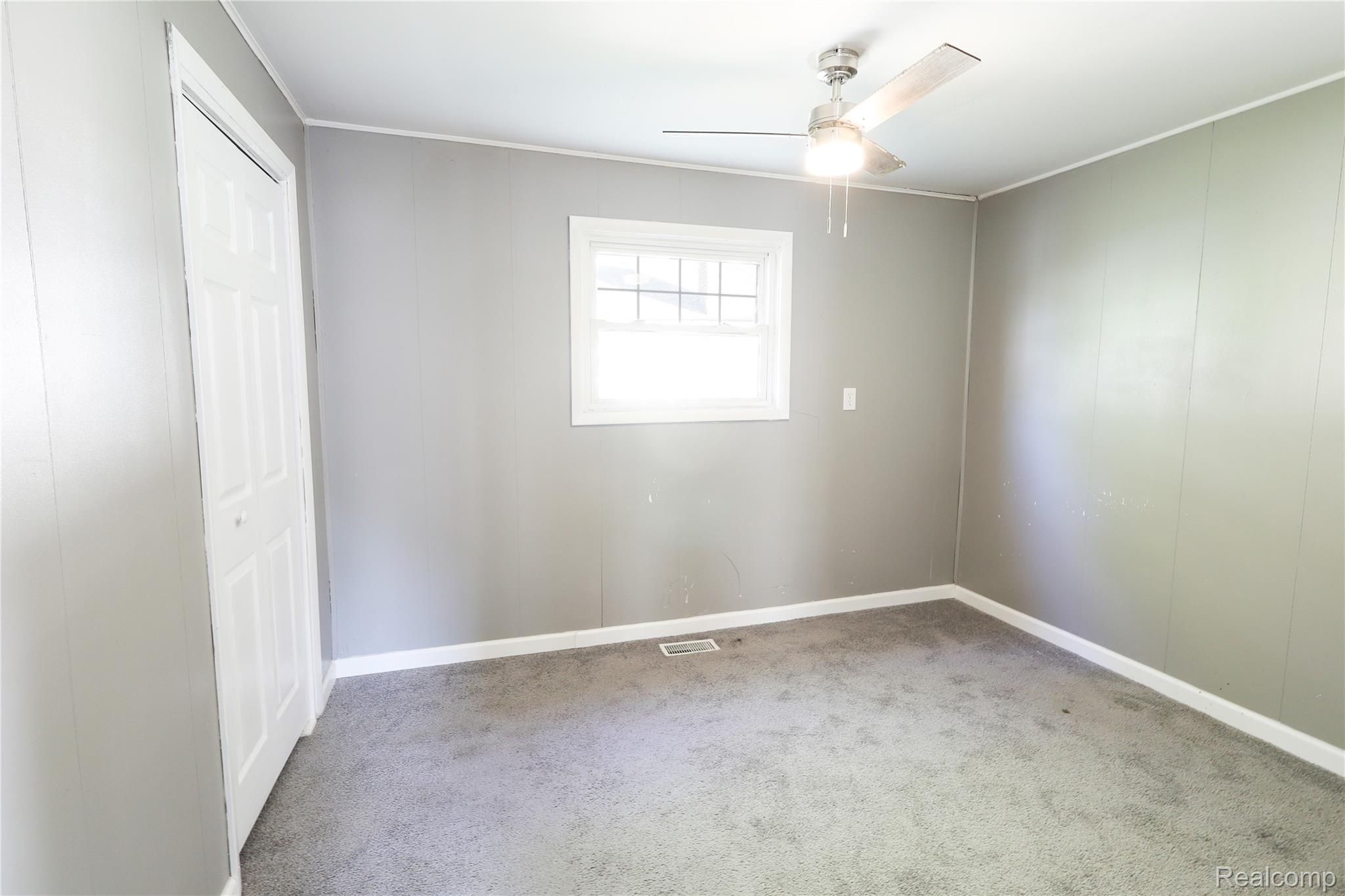 3319 Lakeview Street Monroe, MI 48162 - Photo 18 of 21 Neutral gray walls paired with a light gray carpeted floor