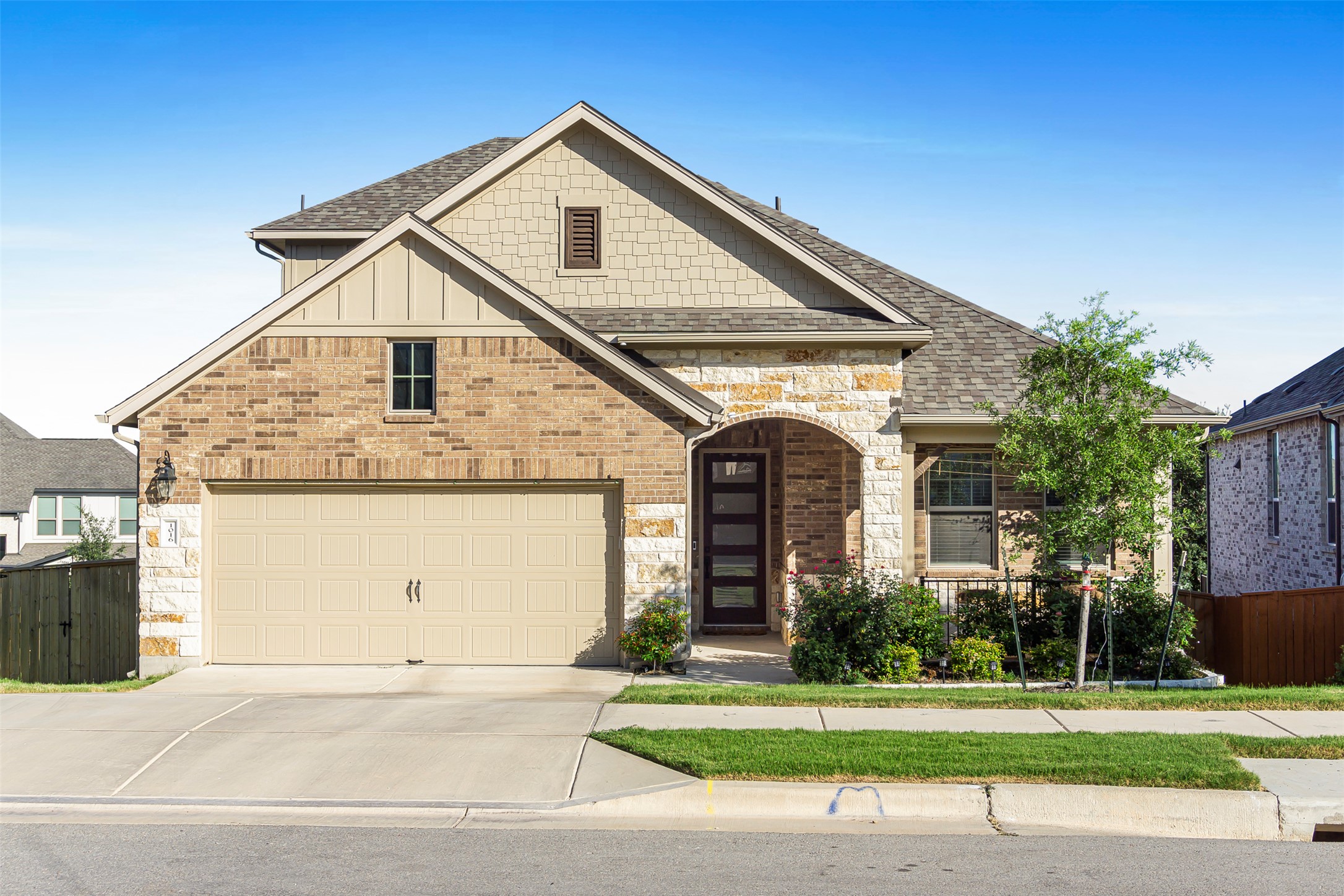 1016 Calendula Trail Georgetown, TX 78628 - Photo 1 of 40 View of front of house with a shingled roof, driveway, stone siding, and brick siding