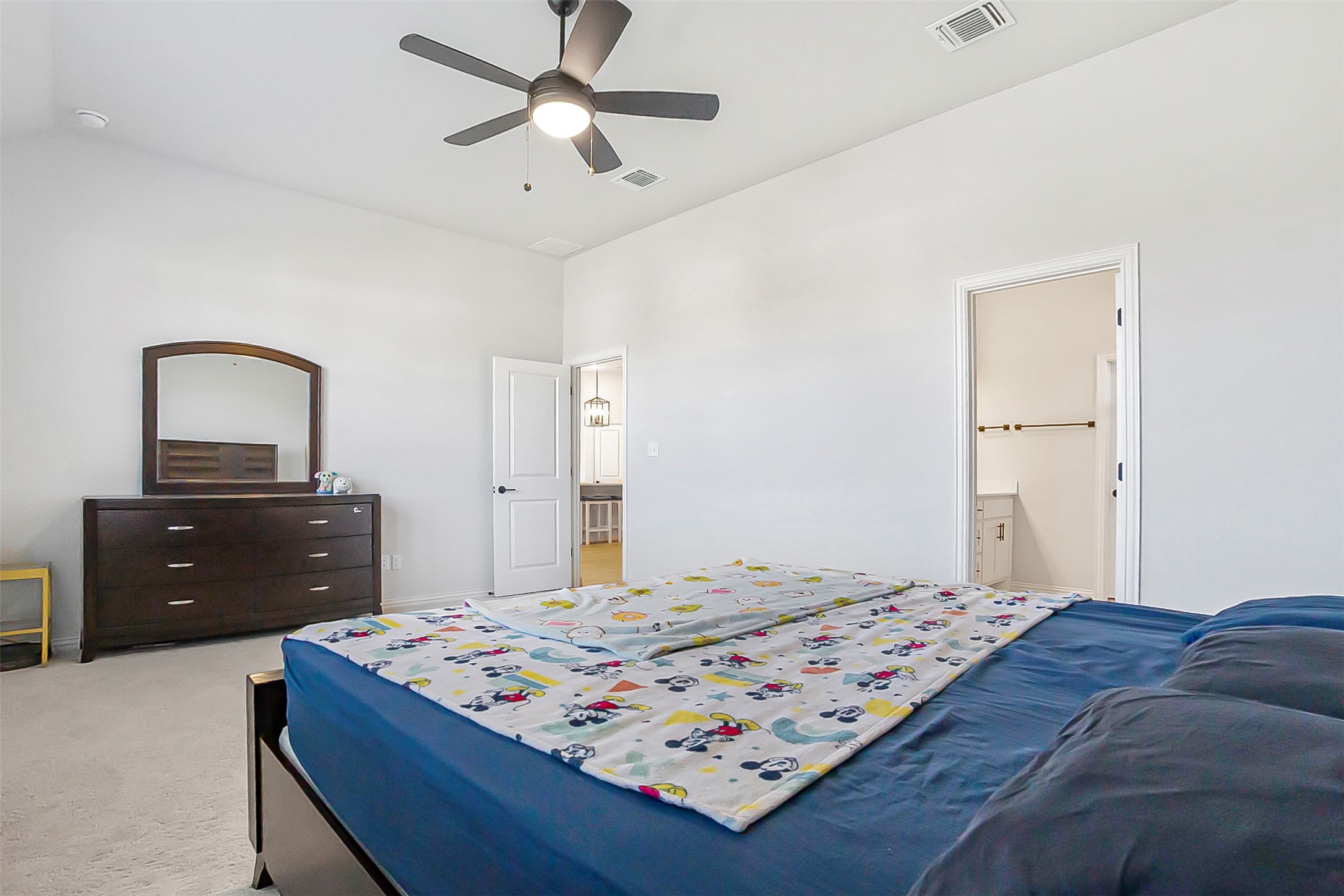 1016 Calendula Trail Georgetown, TX 78628 - Photo 13 of 40 Carpeted bedroom with a ceiling fan, ensuite bathroom, and lofted ceiling