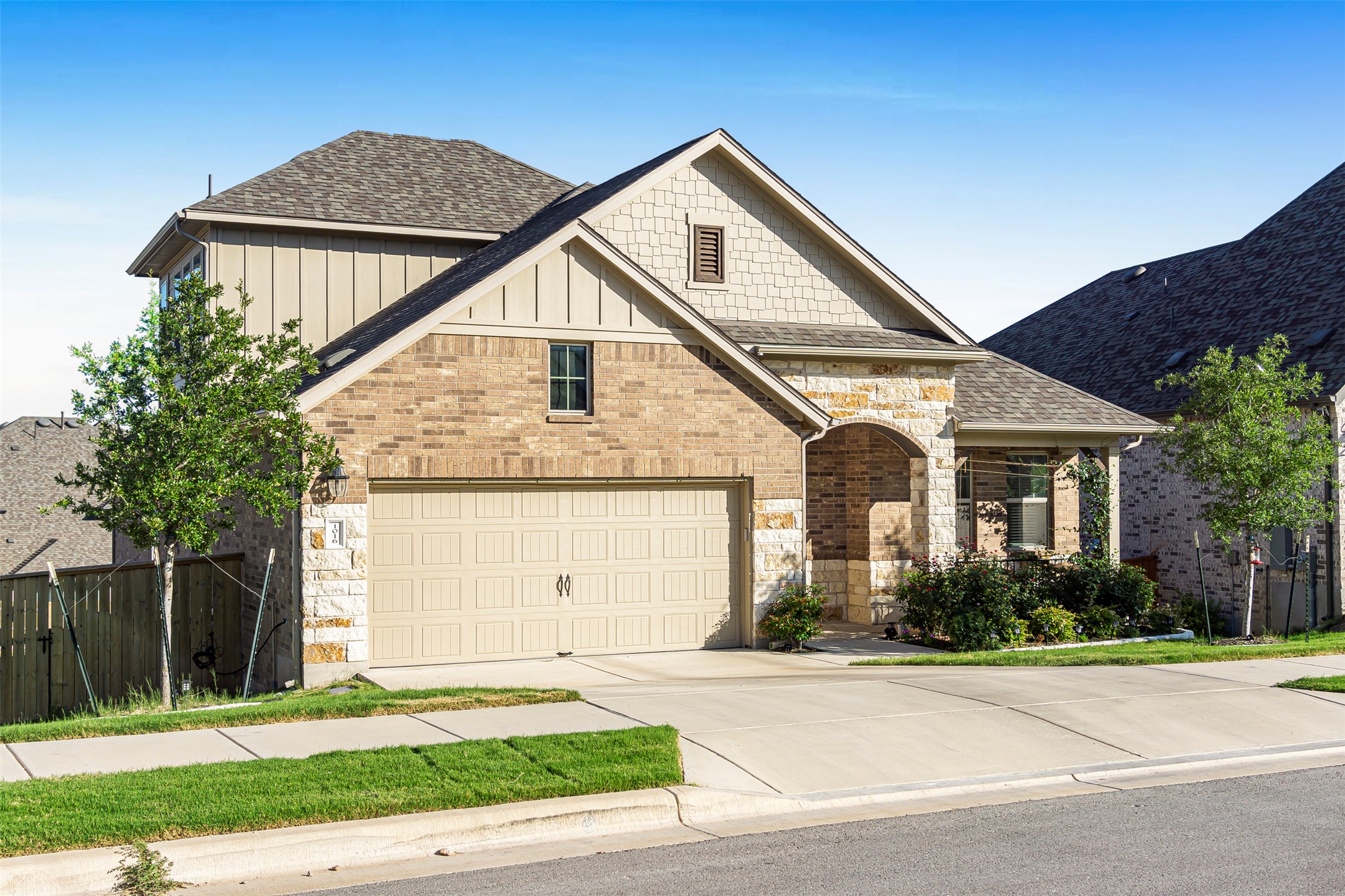 1016 Calendula Trail Georgetown, TX 78628 - Photo 2 of 40 View of front of property featuring roof with shingles, driveway, brick siding, stone siding, and a gate