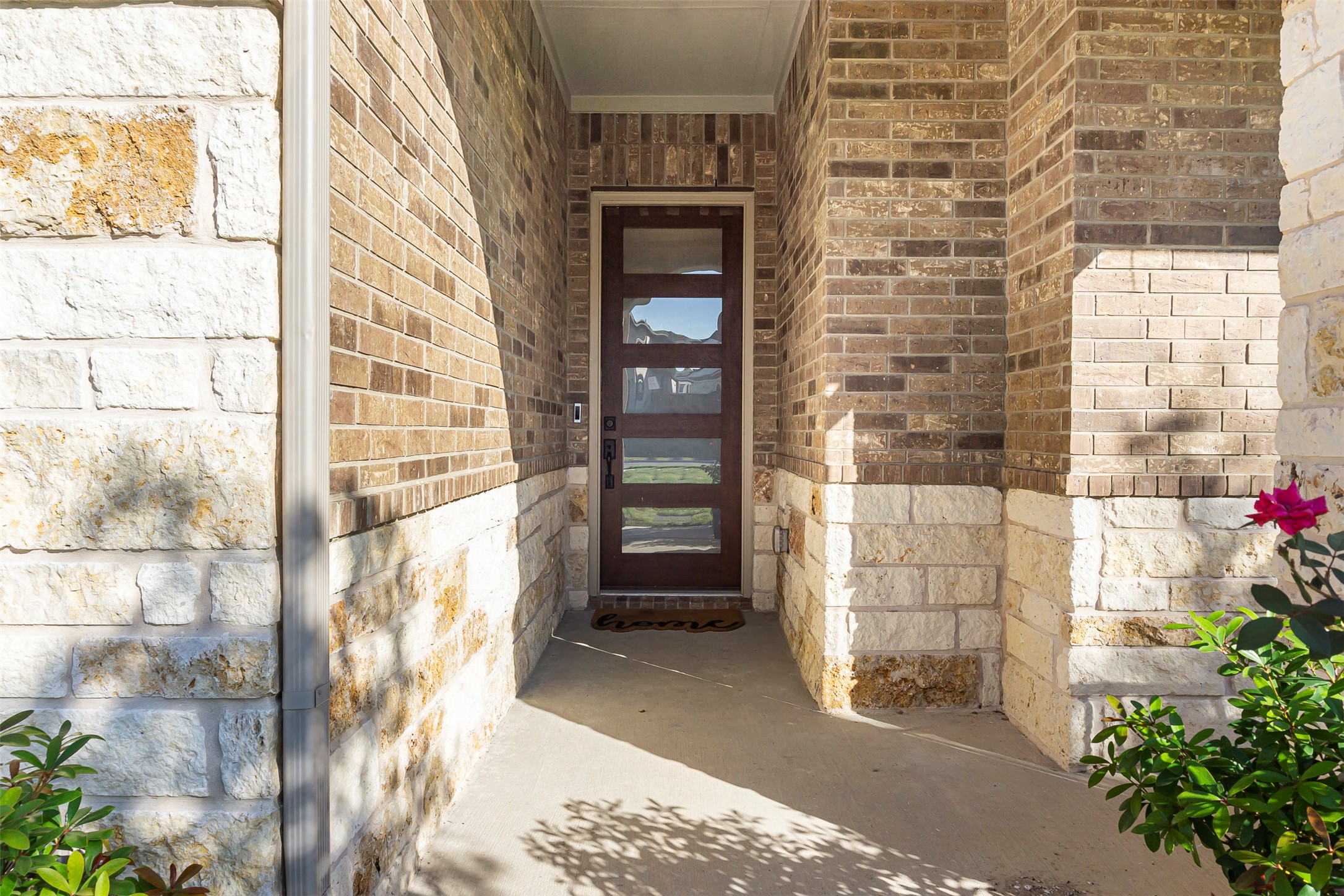 1016 Calendula Trail Georgetown, TX 78628 - Photo 3 of 40 Entrance to property featuring stone siding and brick siding