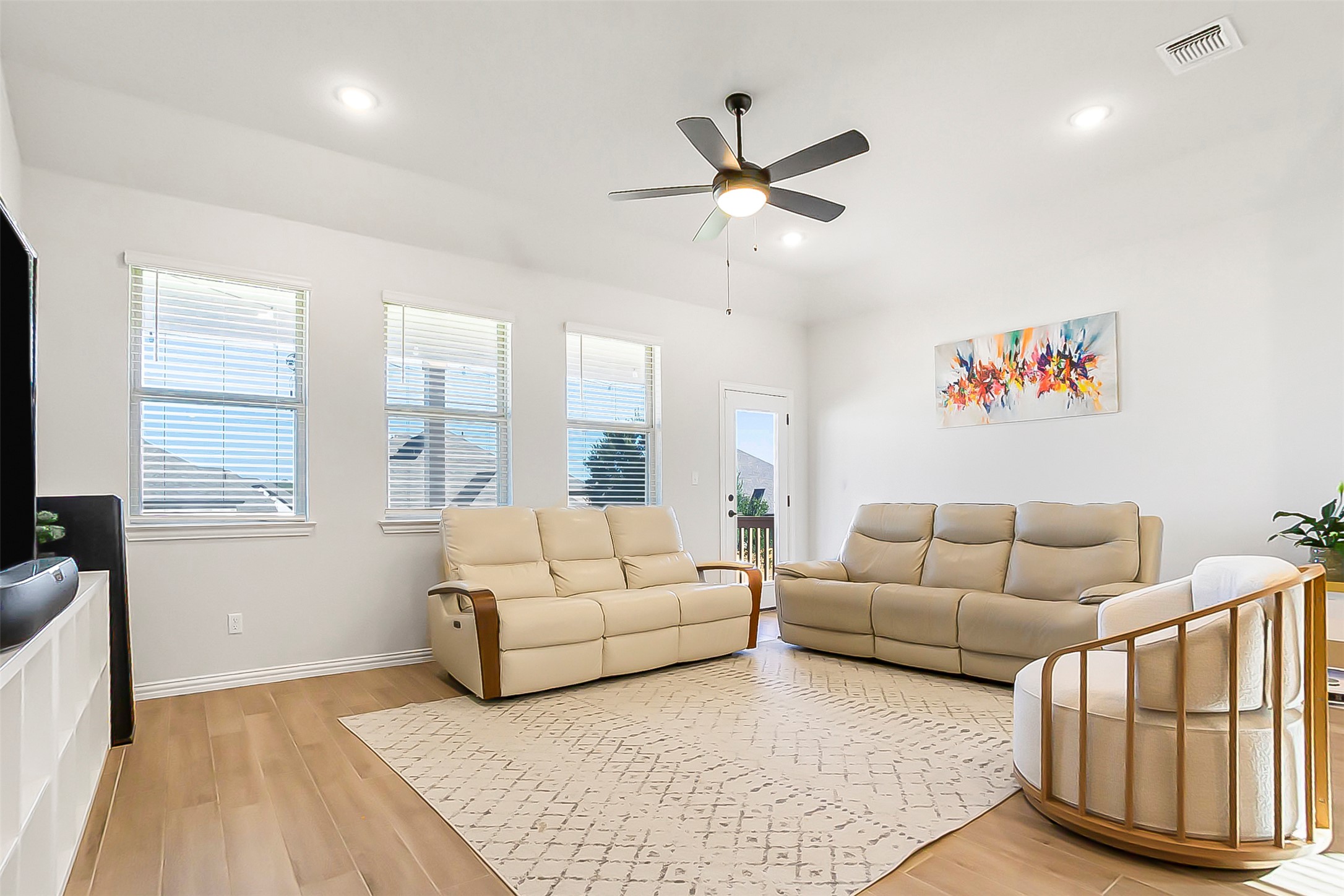 1016 Calendula Trail Georgetown, TX 78628 - Photo 35 of 40 Living room featuring light wood finished floors, ceiling fan, healthy amount of natural light, and recessed lighting