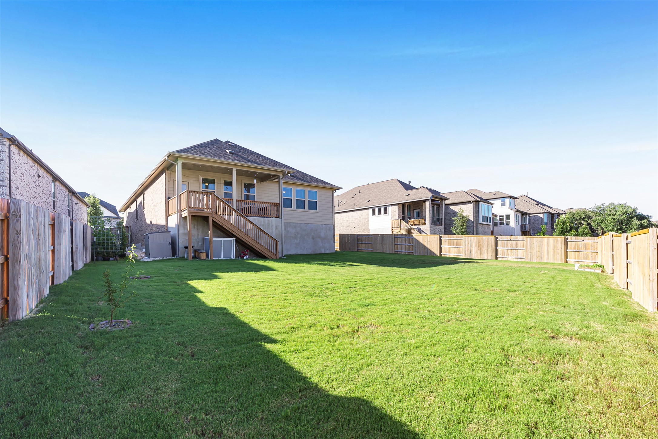 1016 Calendula Trail Georgetown, TX 78628 - Photo 38 of 40 Rear view of house featuring stairs and a fenced backyard