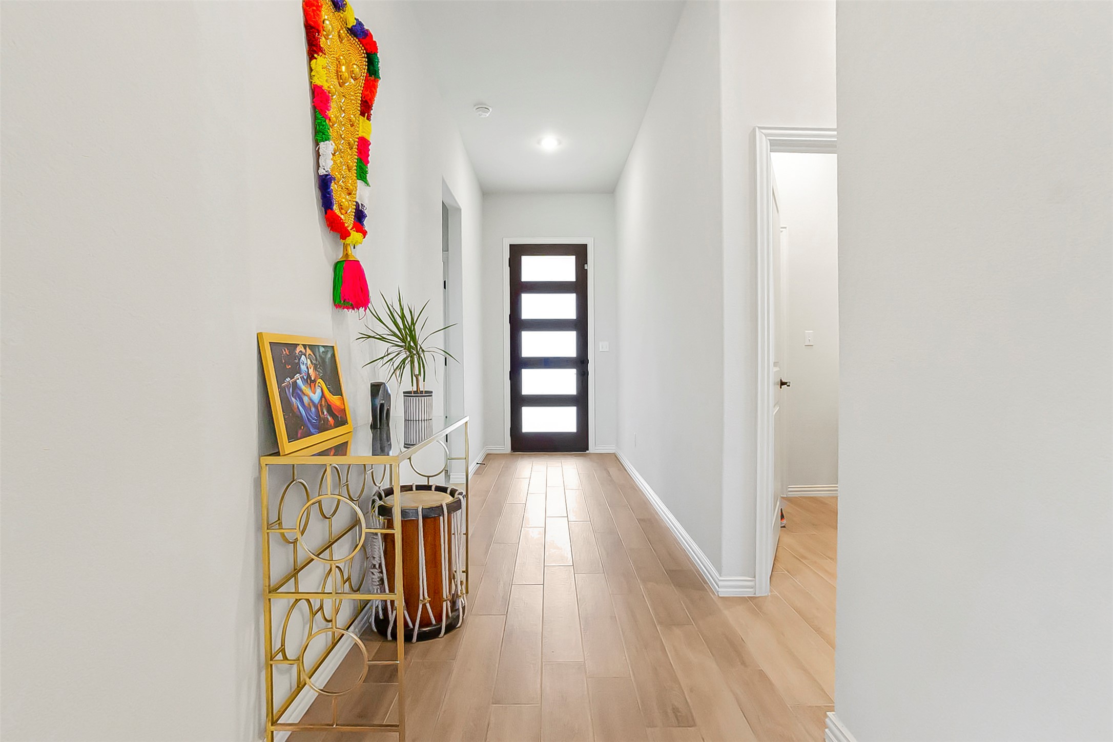 1016 Calendula Trail Georgetown, TX 78628 - Photo 4 of 40 Doorway to outside featuring baseboards and wood finished floors