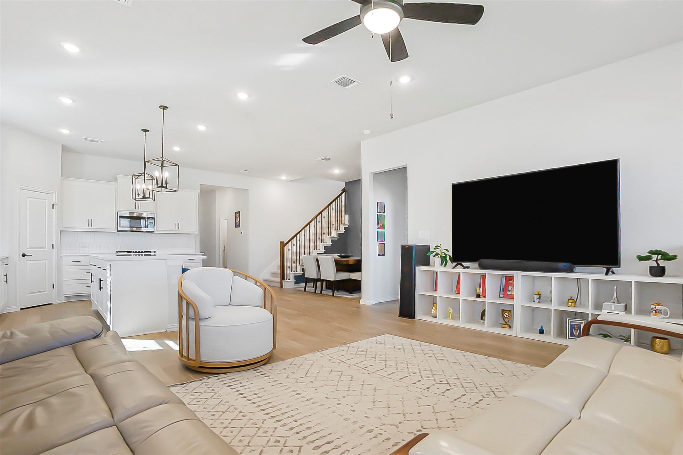 1016 Calendula Trail Georgetown, TX 78628 - Photo 8 of 40 Living area with light wood-style floors, ceiling fan, and hanging lights