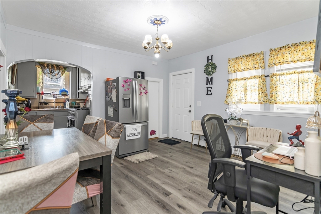 191 Farnham Street Lawrence, MA 01843 - Photo 7 of 31 a view of a workspace with furniture and a chandelier