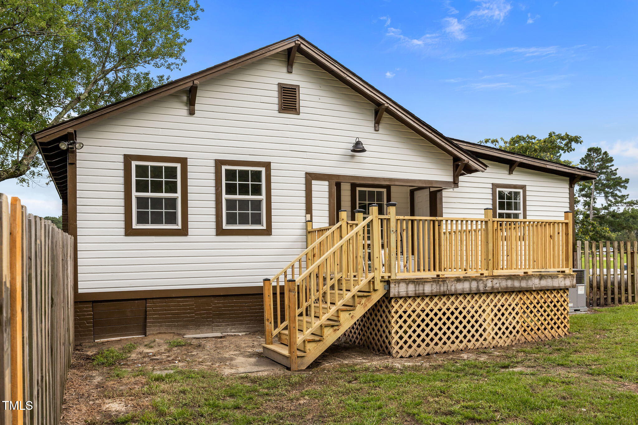 9900 Kennebec Church Road Angier, NC 27501 - Photo 36 of 41 a view of a house with a small yard and wooden fence
