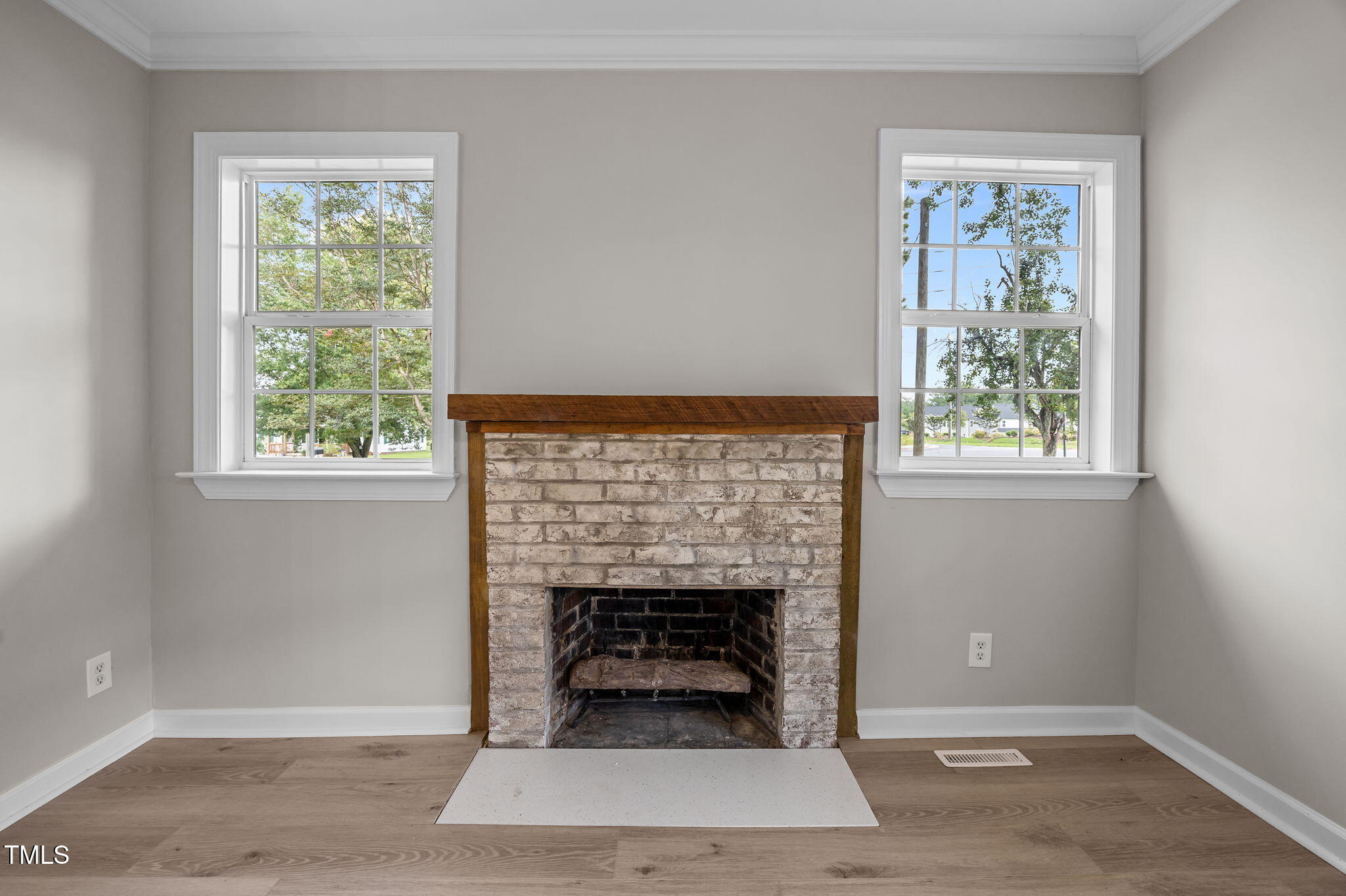 9900 Kennebec Church Road Angier, NC 27501 - Photo 8 of 41 an empty room with a fireplace and window