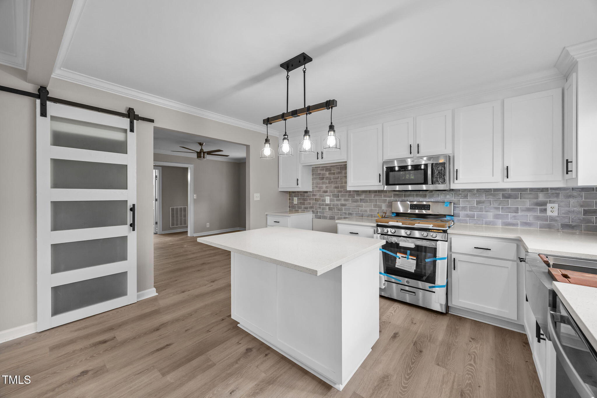 9900 Kennebec Church Road Angier, NC 27501 - Photo 10 of 41 a kitchen with stainless steel appliances a sink stove and wooden floor