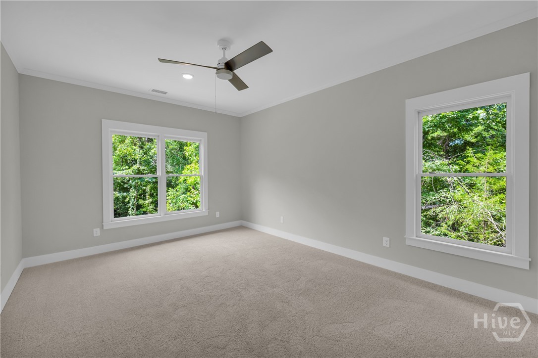 2476 St Martin Way Monroe, GA 30656 - Photo 62 of 75 Spacious room featuring neutral carpeting, light gray walls, white trim, and a ceiling fan with integrated lighting