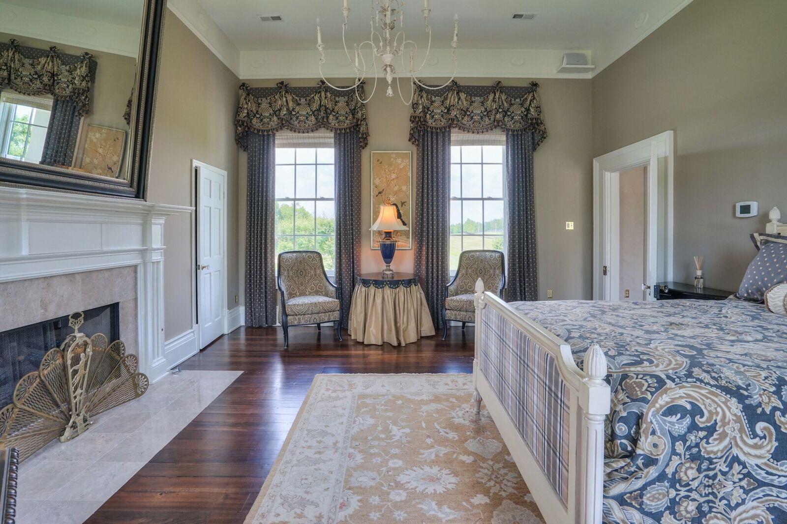 8483 Taliaferro Road Eagleville, TN 37060 - Photo 17 of 30 a spacious bedroom with a balcony a bed and a chandelier