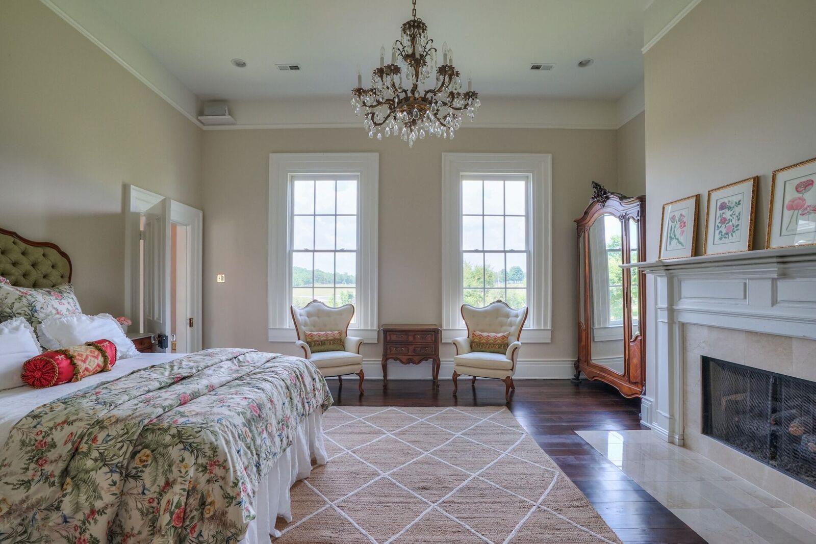 8483 Taliaferro Road Eagleville, TN 37060 - Photo 19 of 30 a bedroom with a large bed and a fireplace