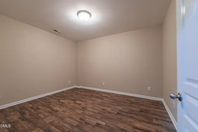 a view of room with wooden floor