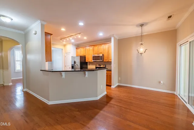 a view of a room with wooden floor and window