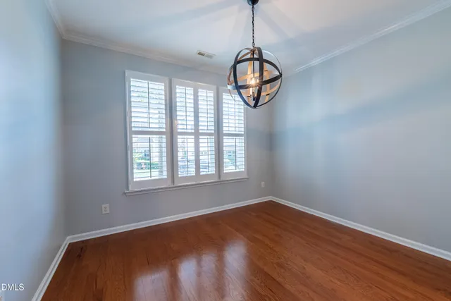 a view of a livingroom with wooden floor and window