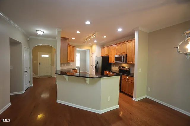 a view of kitchen with cabinets and wooden floor