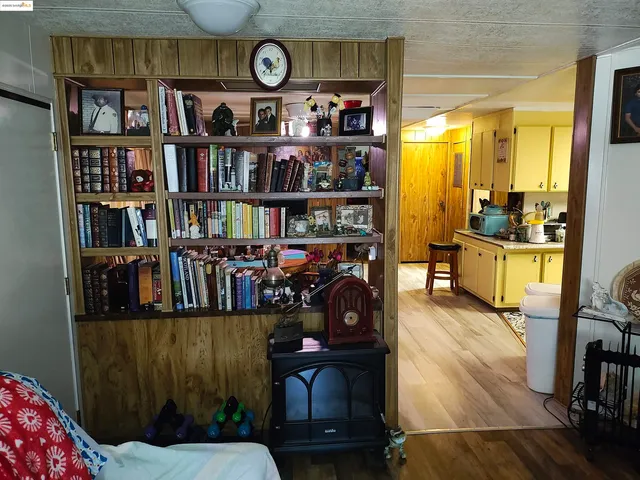 a bed room with a bed and a book shelf