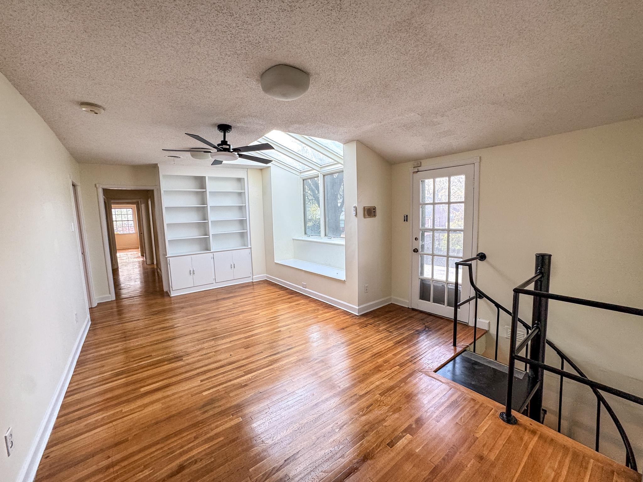1345 Hickory Ridge Cove Memphis, TN 38116 - Photo 1 of 26 a view of empty room with wooden floor and fan