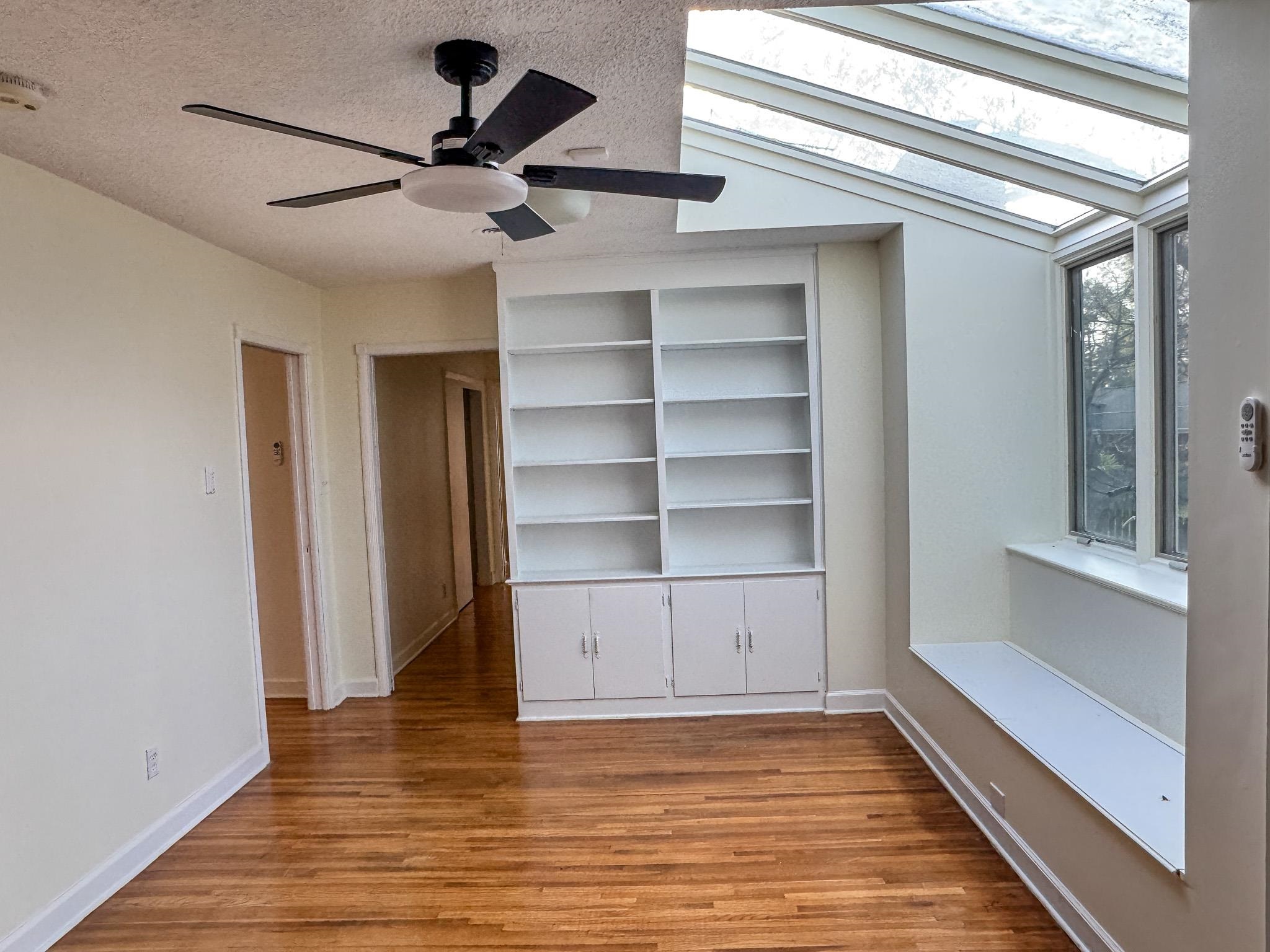 1345 Hickory Ridge Cove Memphis, TN 38116 - Photo 14 of 26 a view of an empty room with a window and wooden floor