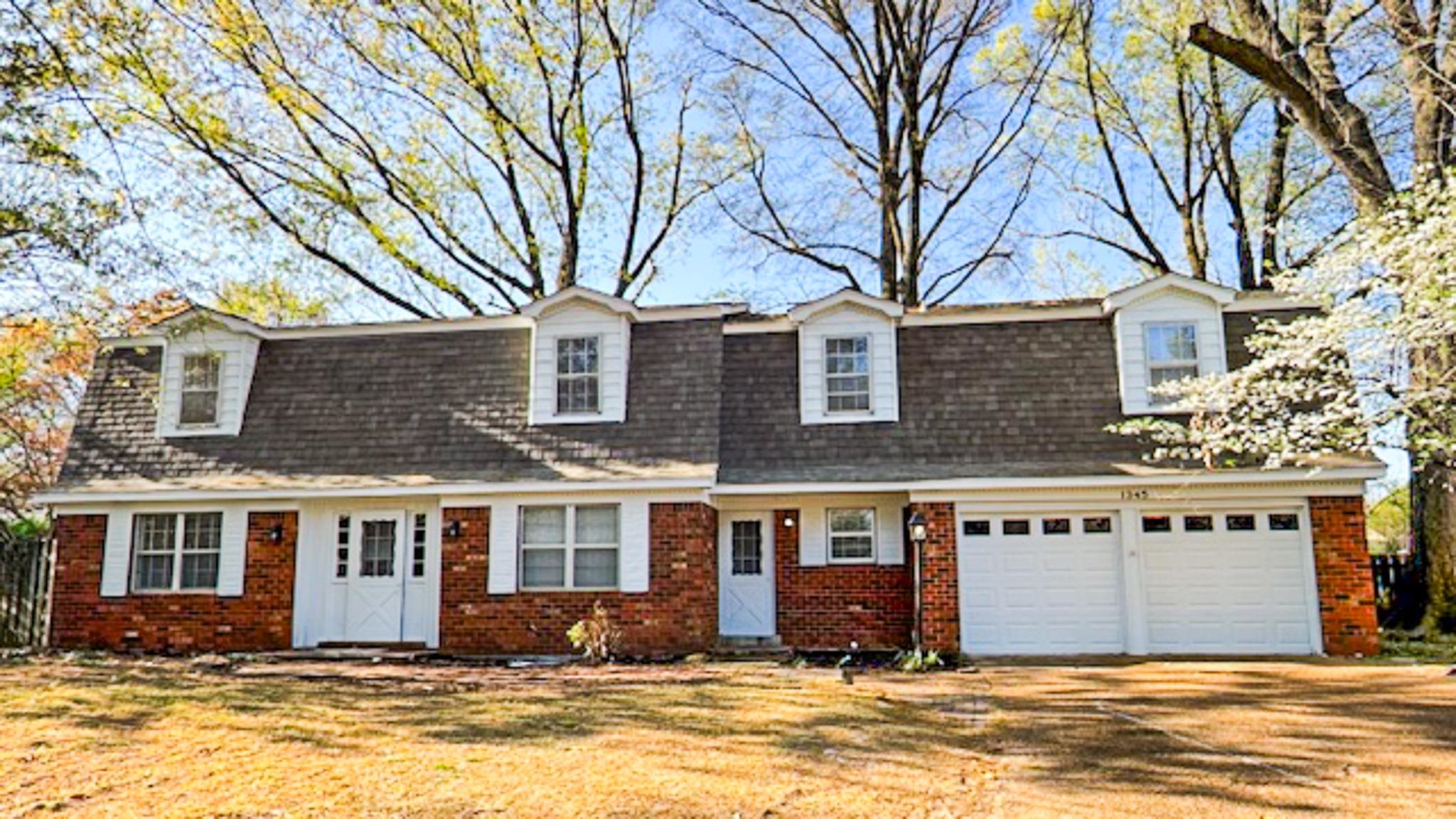 1345 Hickory Ridge Cove Memphis, TN 38116 - Photo 2 of 26 a front view of a house with a yard