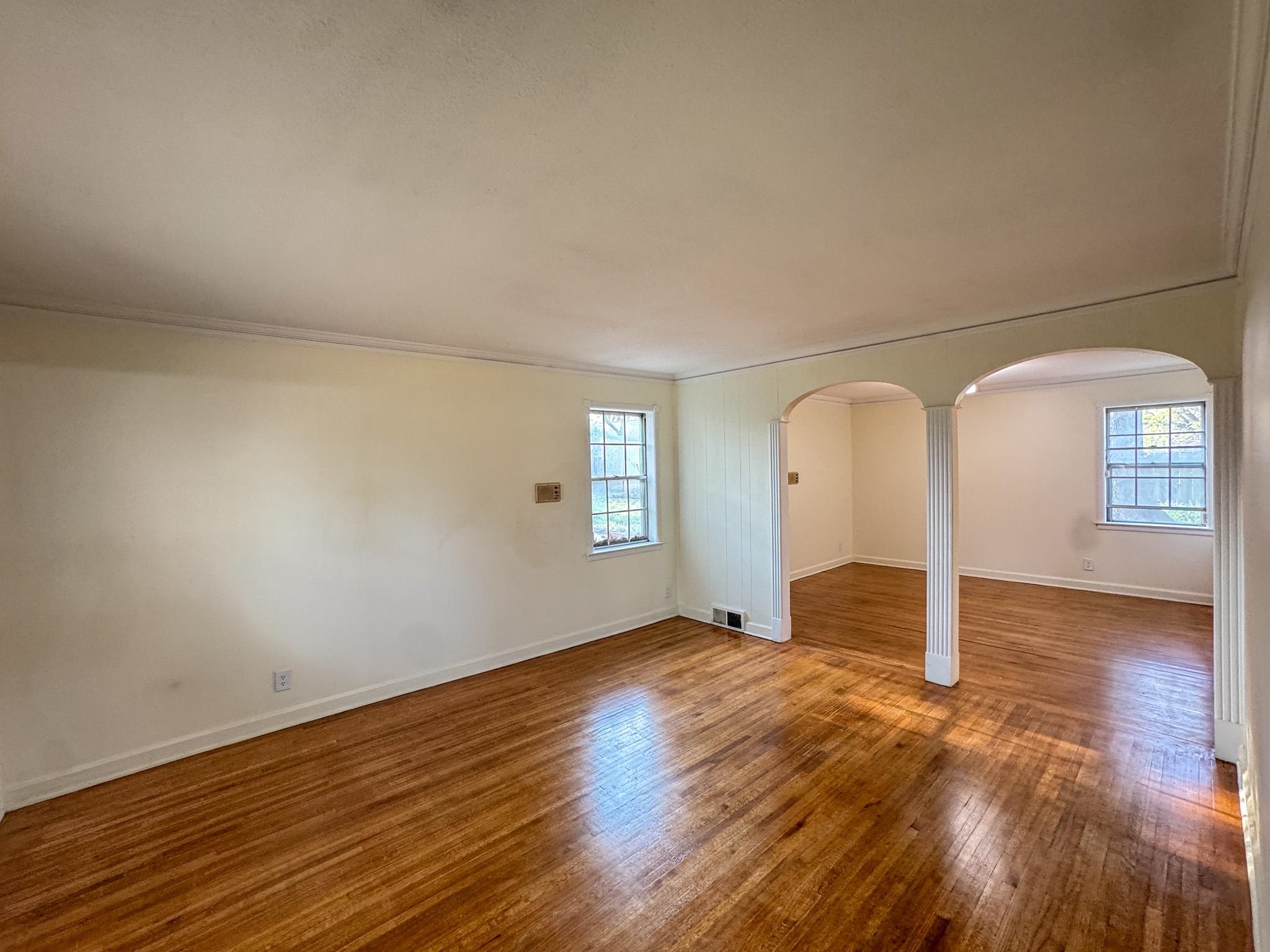 1345 Hickory Ridge Cove Memphis, TN 38116 - Photo 4 of 26 an empty room with wooden floor and windows