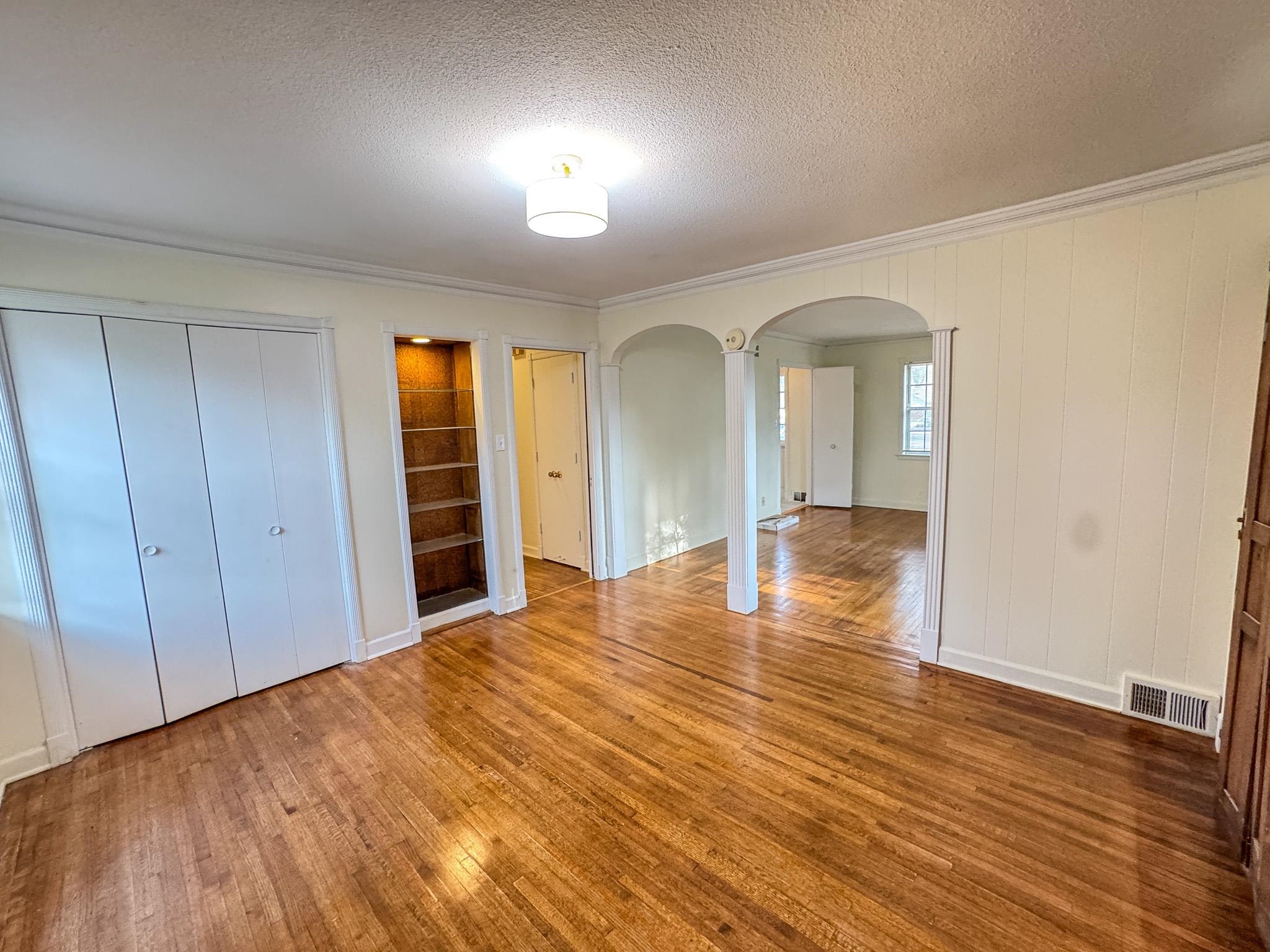 1345 Hickory Ridge Cove Memphis, TN 38116 - Photo 7 of 26 wooden floor in an empty room with a window