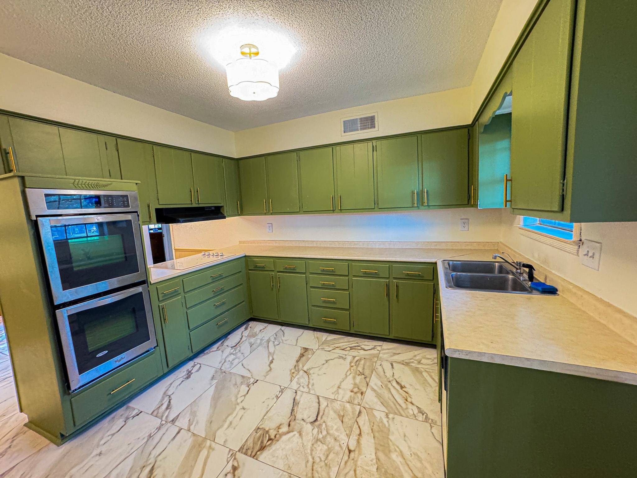 1345 Hickory Ridge Cove Memphis, TN 38116 - Photo 8 of 26 a kitchen with a refrigerator and a sink