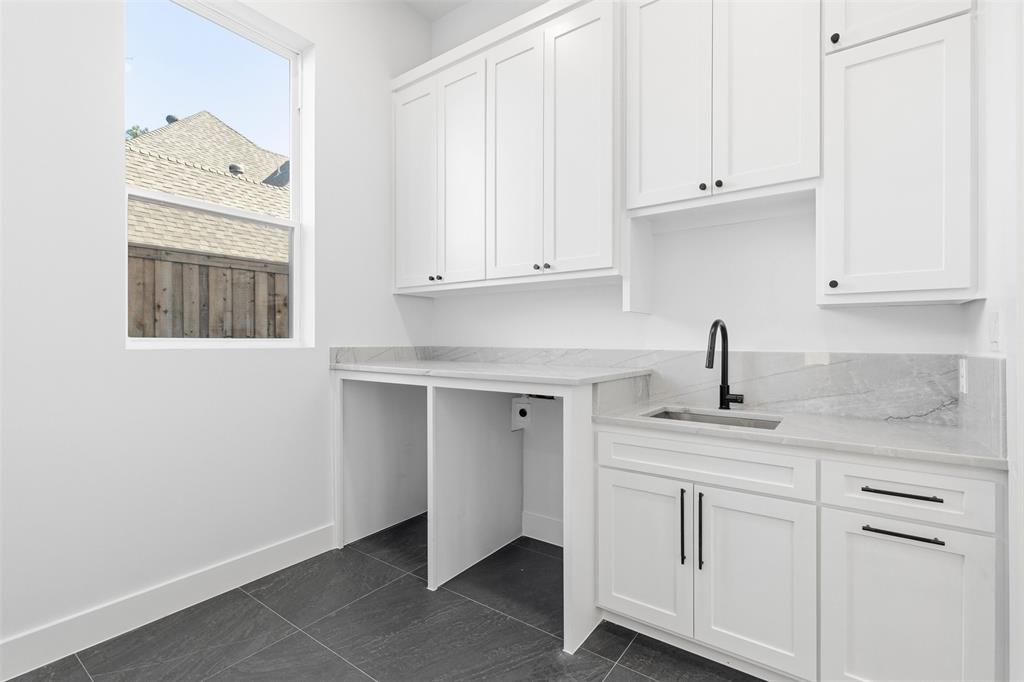 6257 Turner Way Dallas, TX 75230 - Photo 21 of 39 a kitchen with granite countertop white cabinets and sink